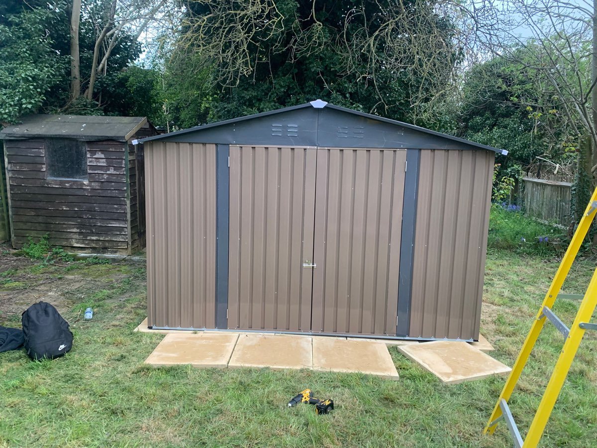 A steel garden shed built and levelled on a fresh paved base